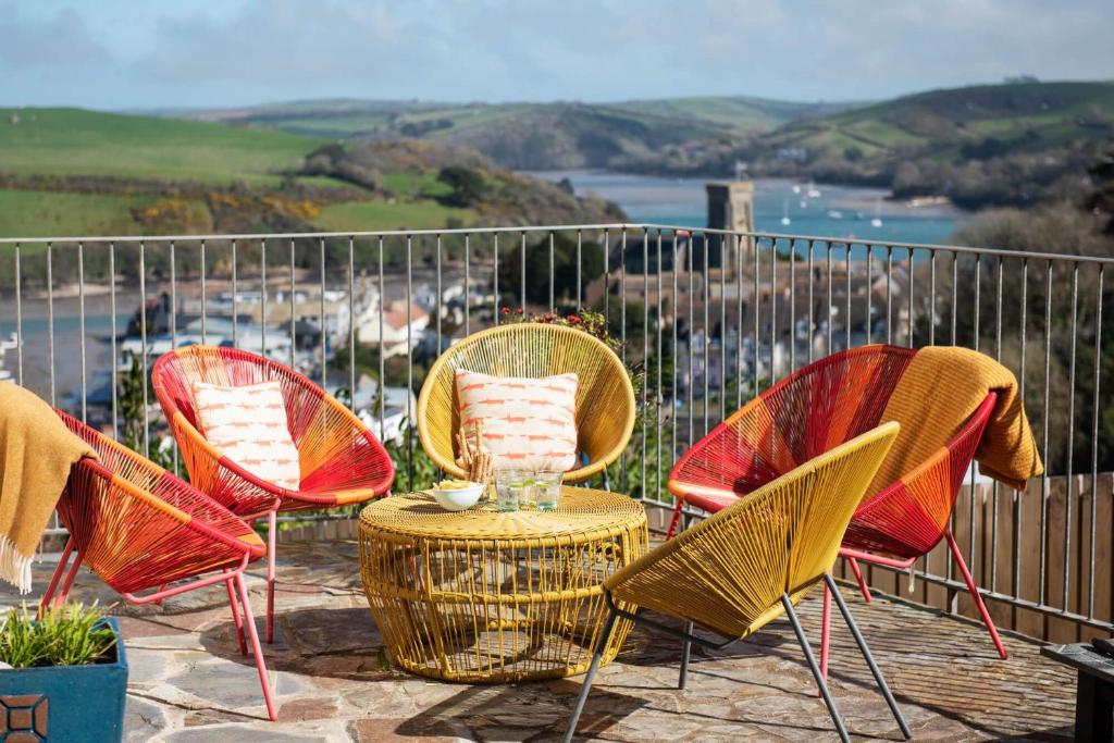 a group of chairs and a table on a patio at Old Sail Loft in Salcombe