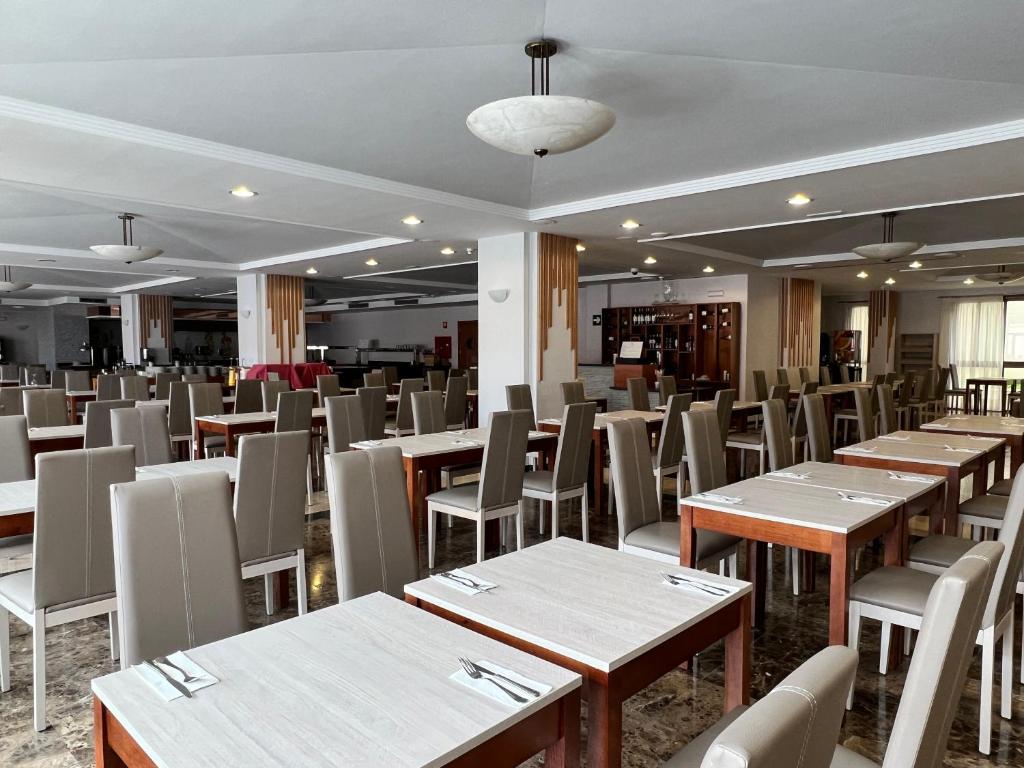 a dining room with wooden tables and chairs at Perla Marina in Nerja