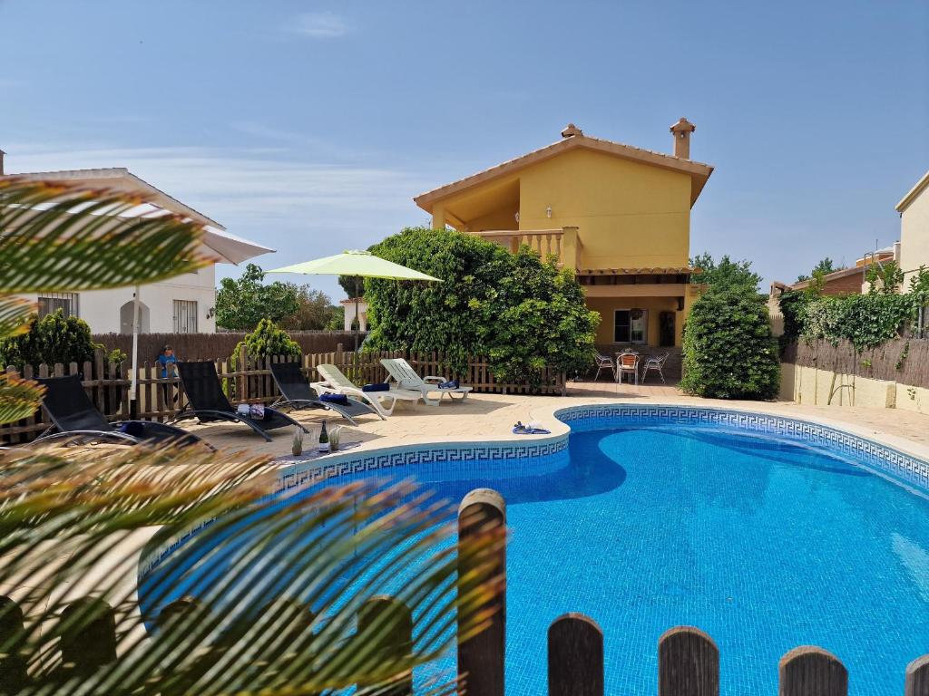 a swimming pool in front of a house at Riumar 'Eva', 300m to beach, private pool, On-Site-Service, dog beach in Riumar