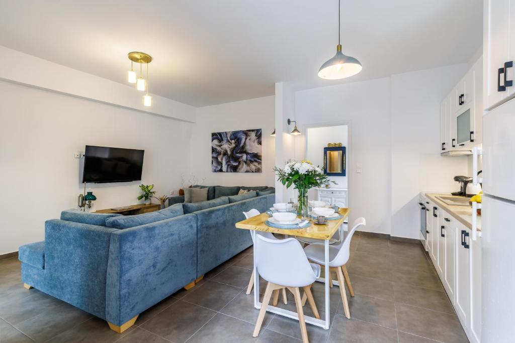 a living room with a blue couch and a table at Servani Apartment in Skopelos Town