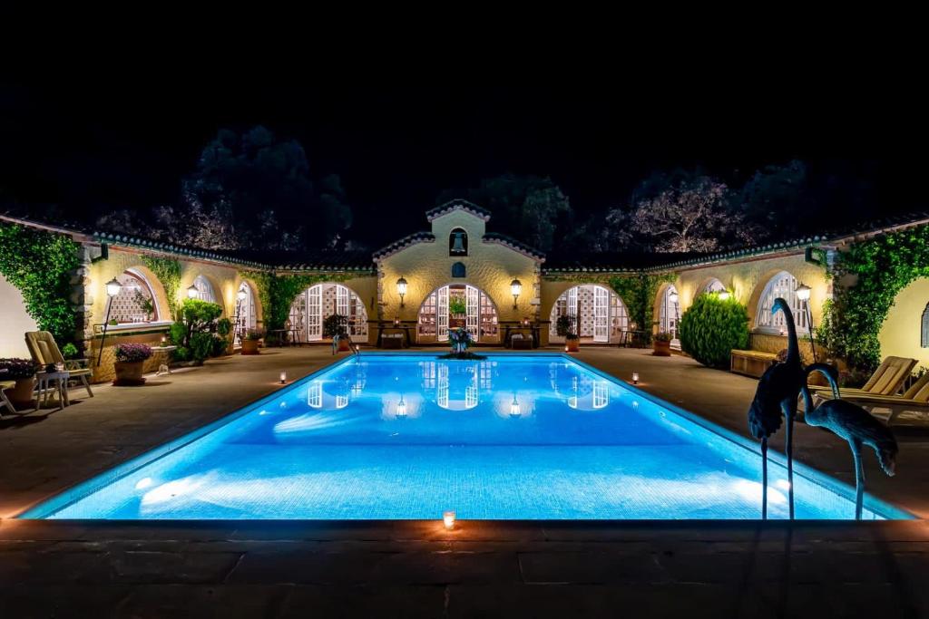 a swimming pool in a house at night at Masia Mimosa Montaña in Darnius