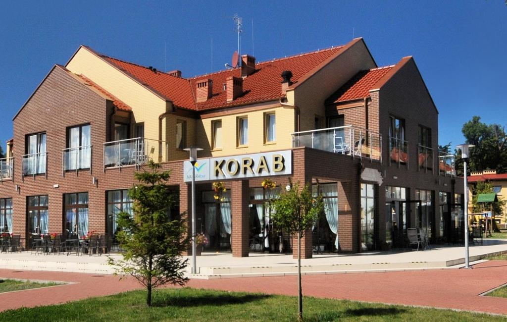 a building with a komed sign on the side of it at Korab Natura Tour in Ustronie Morskie