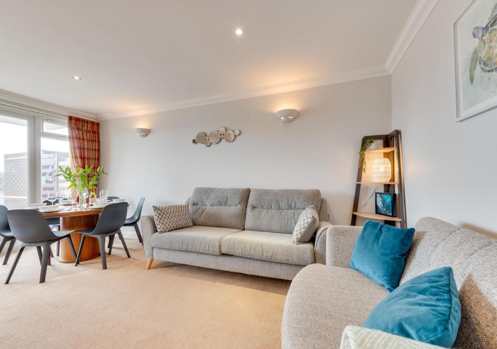 a living room with a couch and a table at Flat 1 Deco in Swanage