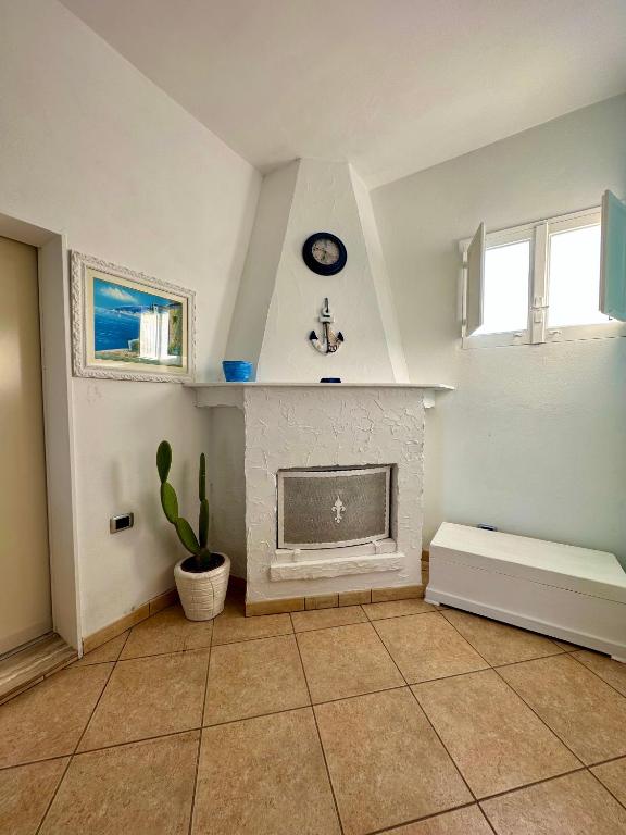 a living room with a fireplace and a window at Villa Santo Stefano in Monopoli