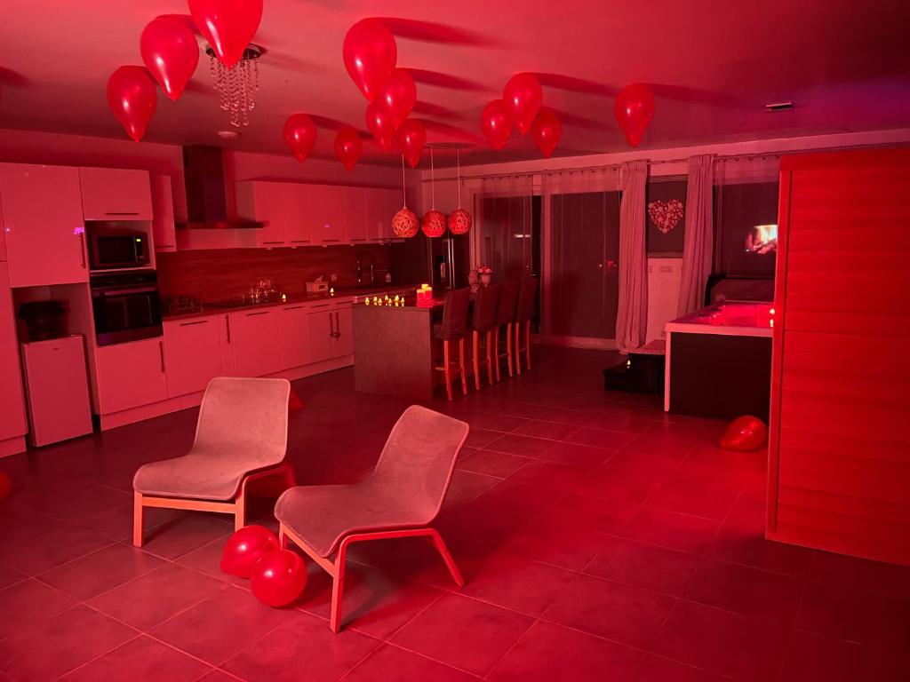 a red kitchen with red balloons hanging from the ceiling at Nid’Ange in Piolenc