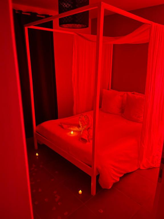 a red bedroom with two bunk beds with red lighting at Nid’Ange in Piolenc