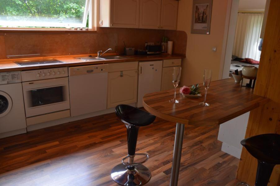 a kitchen with a table with two wine glasses on it at Ferienwohnung am See in Soderstorf in Soderstorf