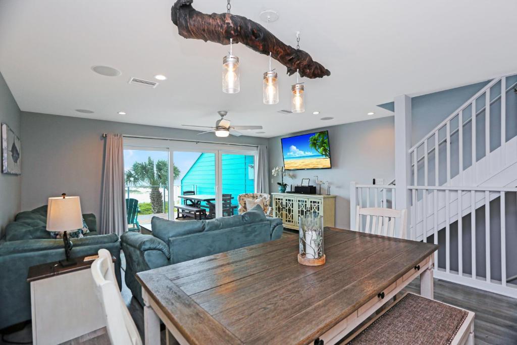 a living room with a table and a couch at Sharla's Sunrise by Pristine Properties Vacation Rentals in Indian Pass