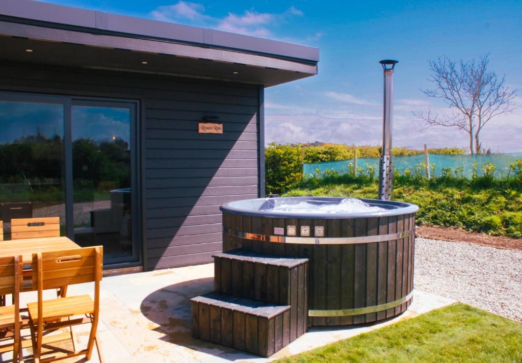 a hot tub in the backyard of a house at Saul Lodges 