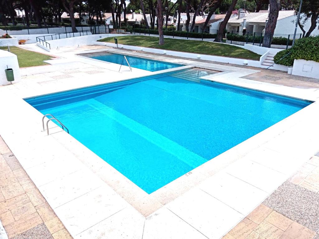 a swimming pool with blue water in a resort at Aldeia das Açoteias, Apartment, WI-FI, in Albufeira