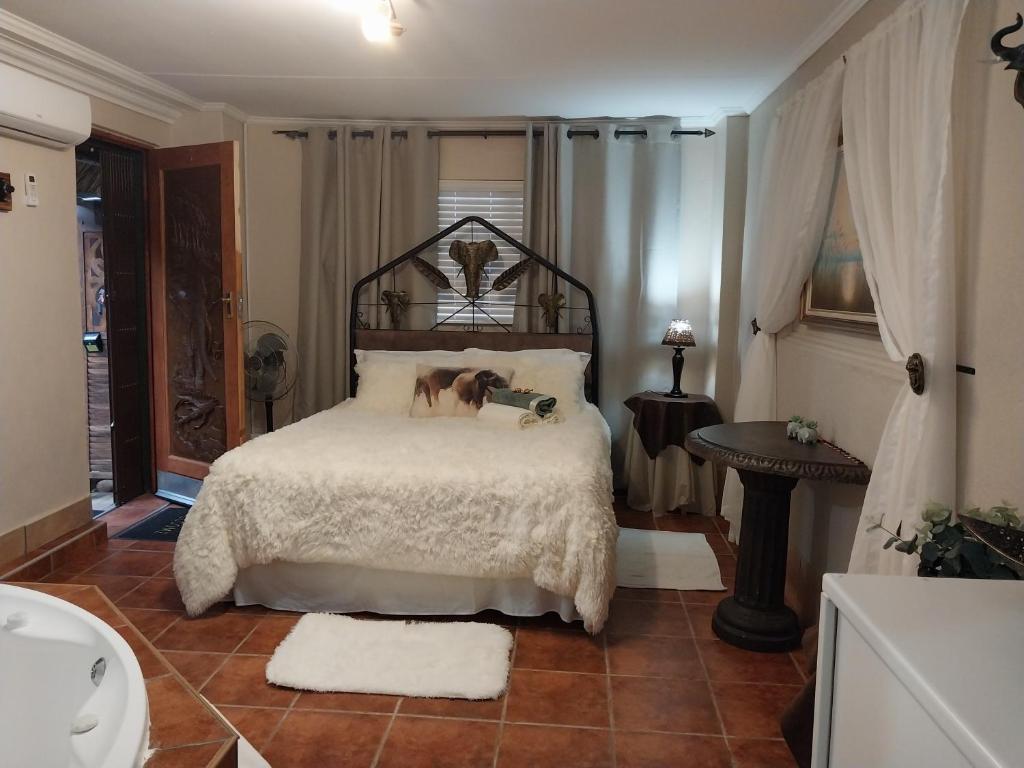 a bedroom with a bed with a dog on it at African Elephant's Den in Klerksdorp