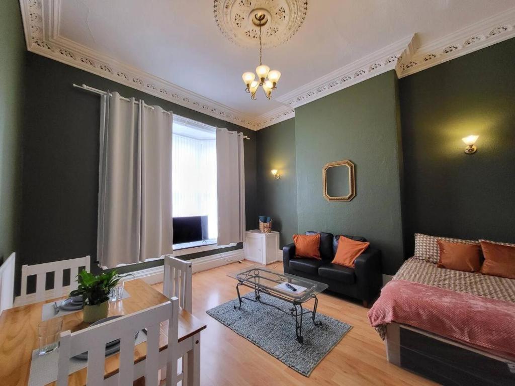 a living room with a bed and a couch and a table at Digbeth City Centre Apartment Sleeps 12 Opposite Coach Station in Birmingham