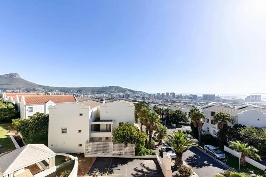 an aerial view of a city with buildings and palm trees at Colourful & cheery Devils' Peak Views 3BD home in Cape Town