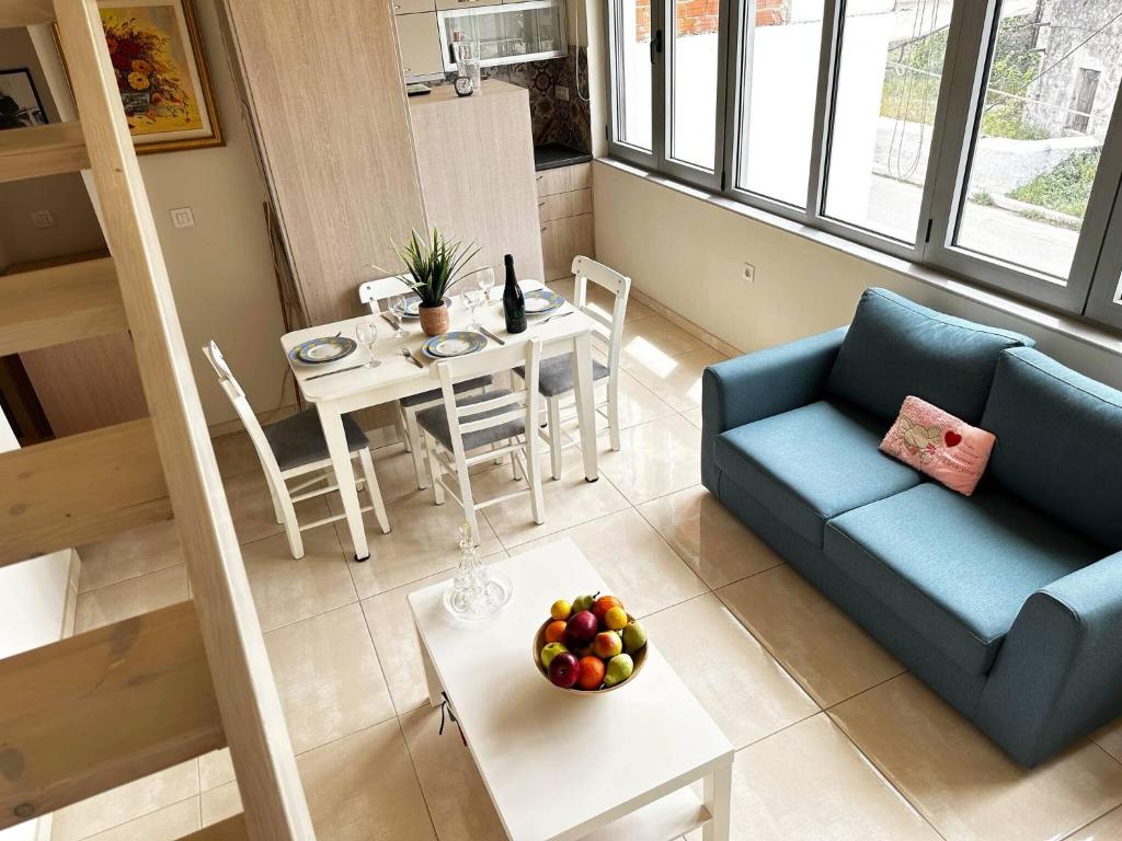 a living room with a couch and a table with a bowl of fruit at Sea Esta Next To Marathi Beach in Stérnai