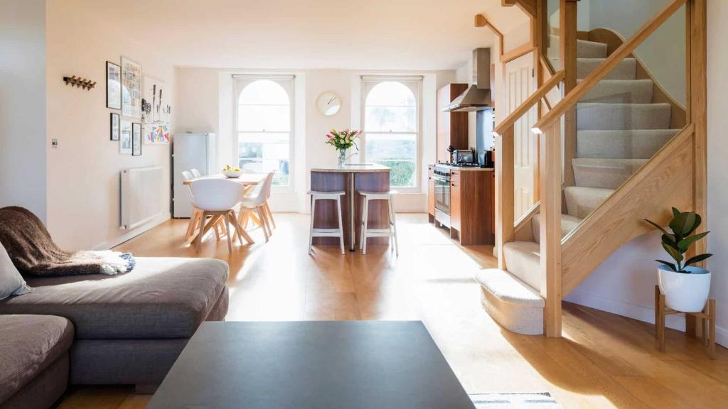 a living room with a couch and a table at Upper Seaton in Salcombe