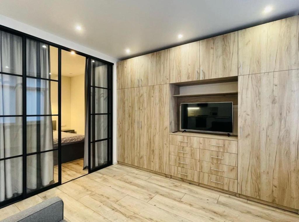 a living room with a tv on a wall at Residential complex Parkland in Kyiv