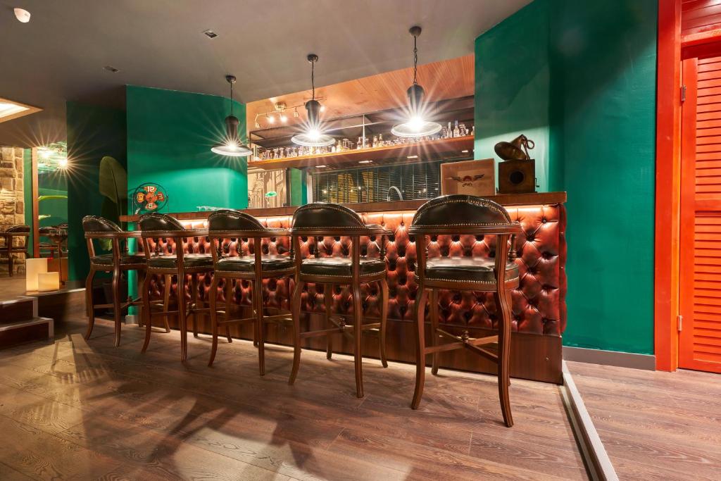 una fila de sillas en un bar con paredes verdes en Azuu Boutique Hotel en Antalya