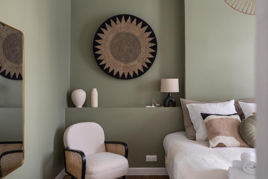 a bedroom with a bed and a chair and a mirror at Le Goya - Appartement 4 chambres centre ville de Rennes in Rennes