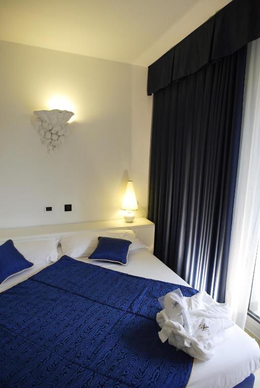 Posteľ alebo postele v izbe v ubytovaní Hotel Luxor
