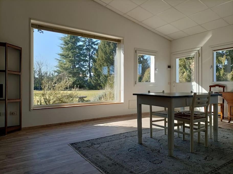- un salon avec une table et une grande fenêtre dans l'établissement Open space Villa Miani, à Silea