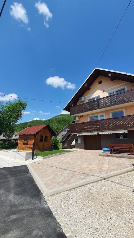 a building with a bench in front of it at Apartment Tijana in Nomenj