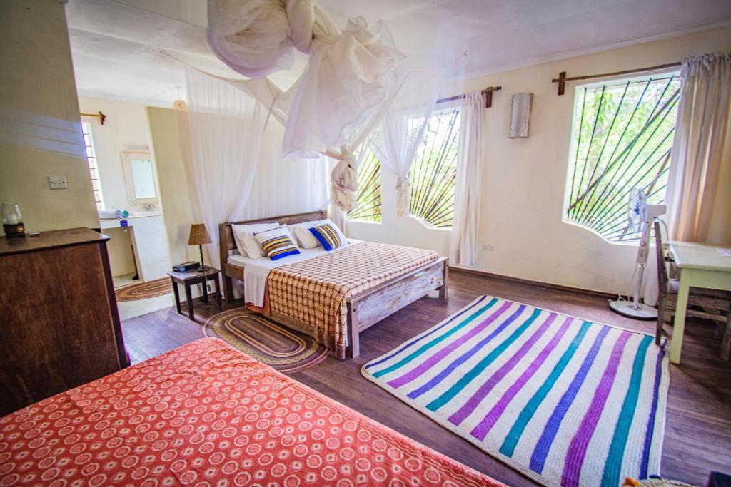 Postel nebo postele na pokoji v ubytování Mami Wata House