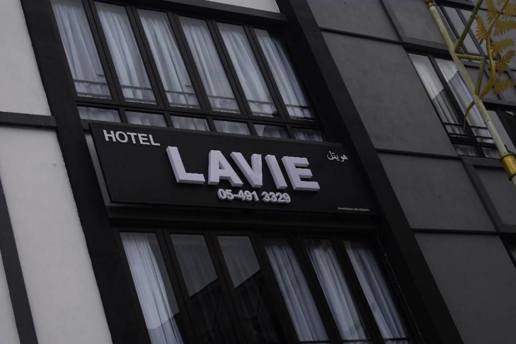 un panneau d'hôtel sur le côté d'un bâtiment dans l'établissement LAVIE HOTEL & APARTMENT, à Brinchang
