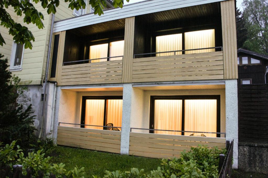 a house with a large deck on the side of it at Pension Winkel in Braunlage