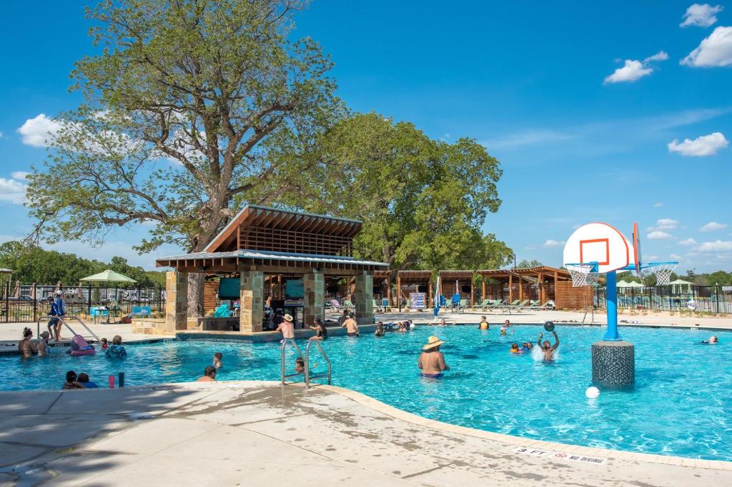 a group of people in a pool at a water park at Camp Fimfo Waco in Waco