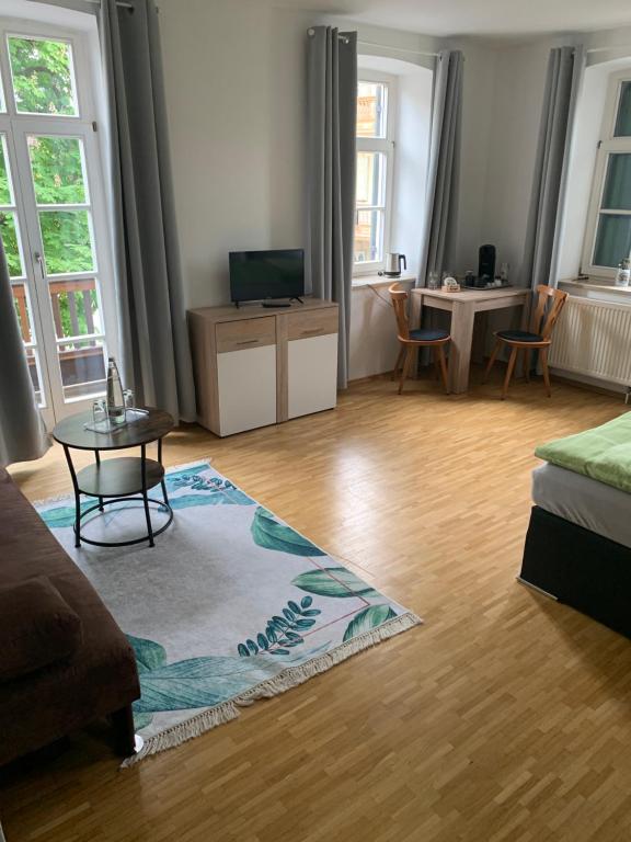 a living room with a couch and a table at Gasthaus Franz Inselkammer in Höhenkirchen-Siegertsbrunn