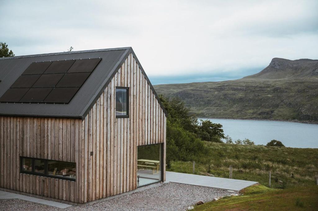 a house with a solar roof on top of a hill at Ardlearag in Garve