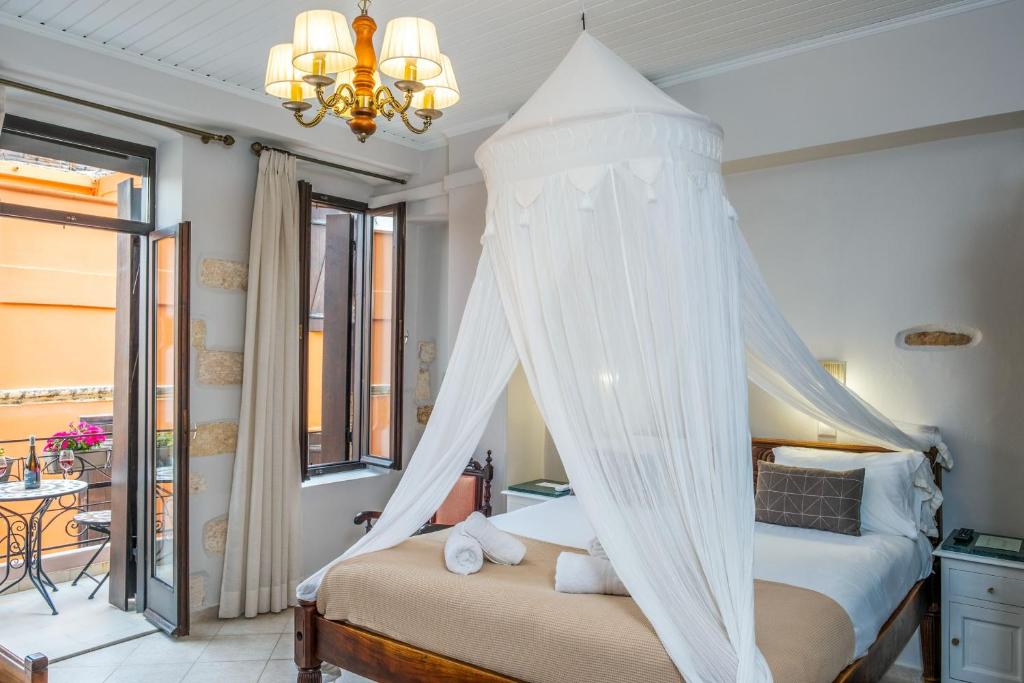 a bedroom with a bed with a canopy at Santa Elena Boutique Rooms in Chania