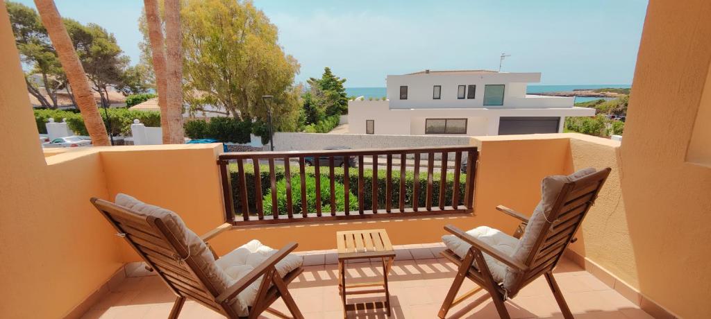 two chairs and a table on a balcony at Casita Vista Mar Duplex - Son Xoriguer in Son Xoriguer