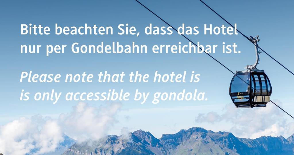 a gondola ride in the sky over mountains at Berghotel Trübsee in Engelberg