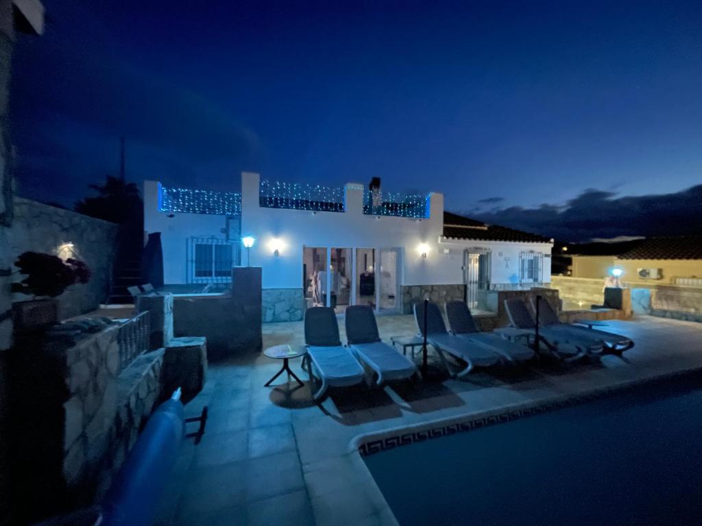 a villa with a swimming pool at night at Casa Olivia villa in Arboleas