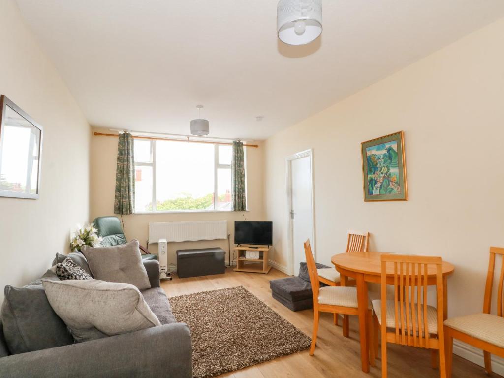 a living room with a couch and a table at Apartment 3 in Lytham St Annes