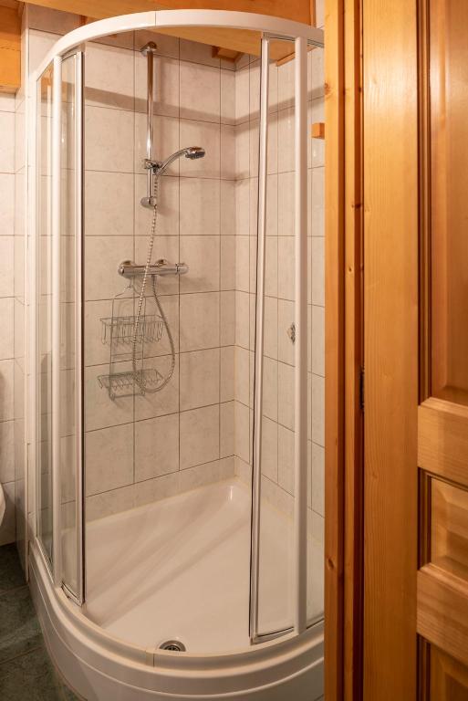 a shower with a glass door in a bathroom at Chalet Le Lapye in Les Gets