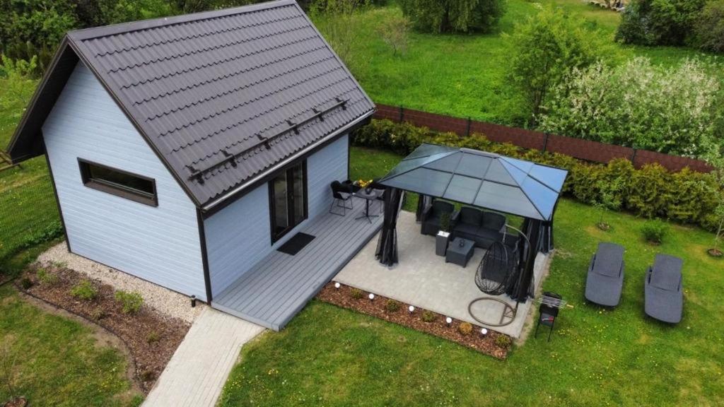 an overhead view of a small shed with a table and umbrella at Tiny House Cēsis in Cēsis