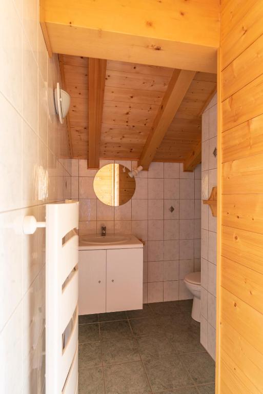 a bathroom with a sink and a toilet at Chalet Le Lapye in Les Gets
