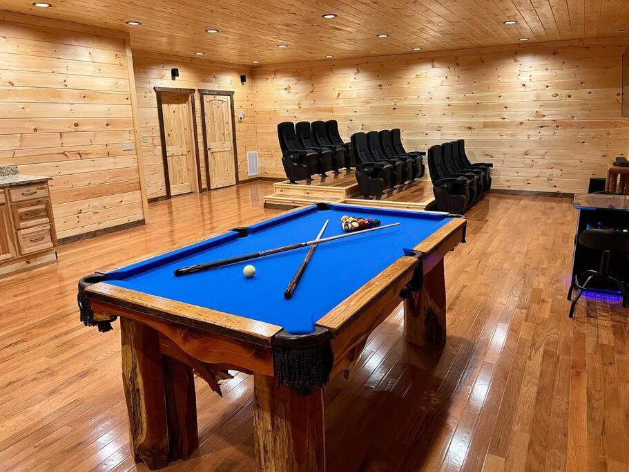 a pool table in a room with black chairs at * * 4 Master Bedrooms, Views, Theater, Arcade, EVC in Gatlinburg
