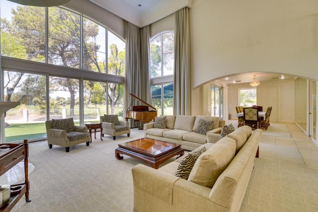 a large living room with a couch and a piano at Elegant Las Vegas Estate with Pool about Near Golf and Strip in Las Vegas