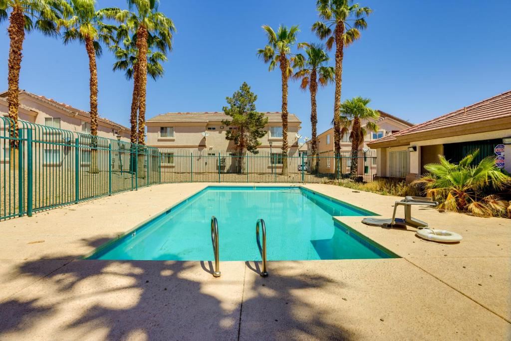 a swimming pool in a yard with palm trees at Las Vegas Condo with Private Balcony 10 Mi to Strip in Las Vegas
