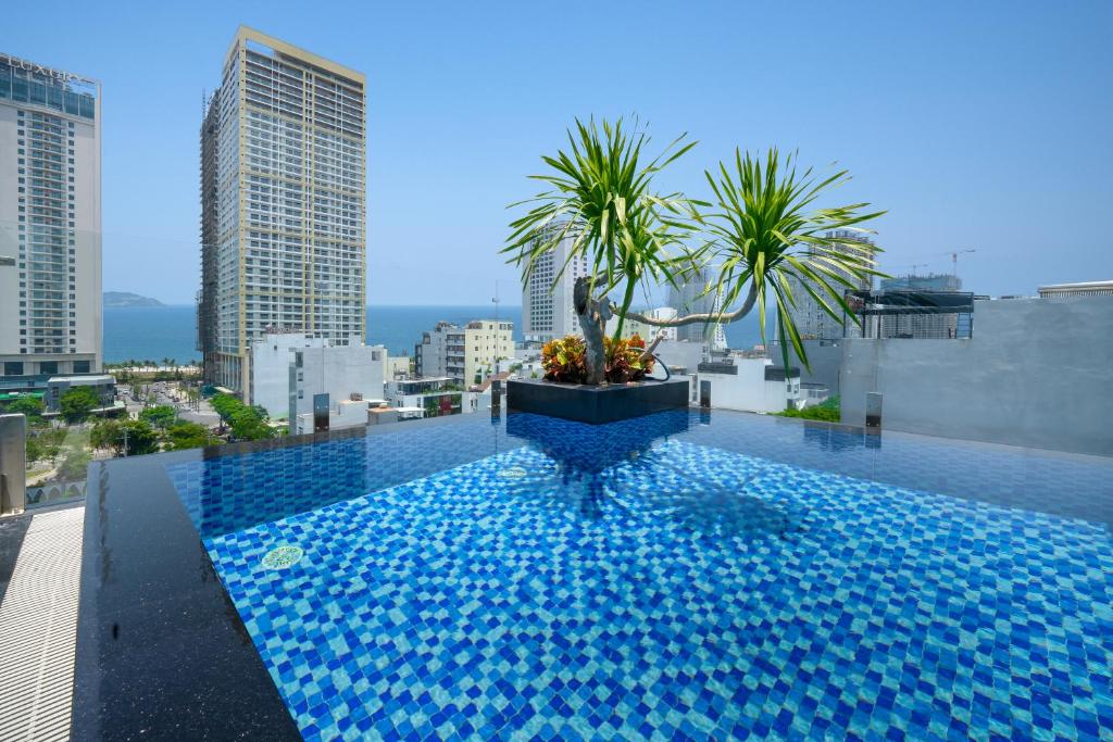 a swimming pool on the roof of a building at Tashi Ocean Hotel & Apartment Da Nang in Da Nang