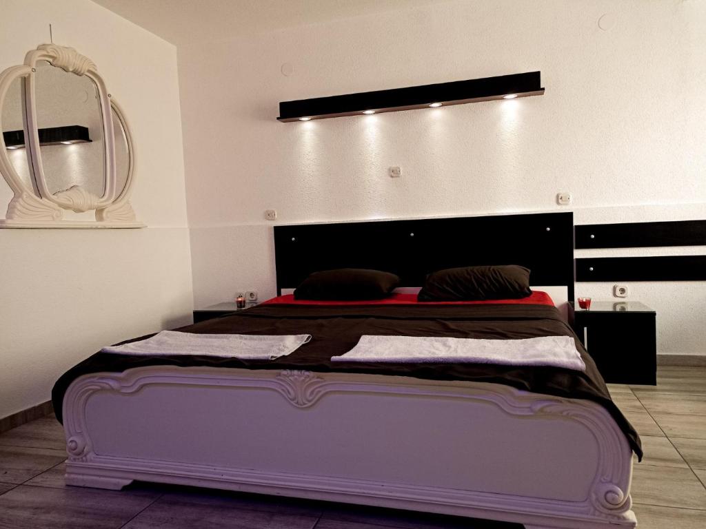 a large bed in a room with a mirror at Kice Apartments in Ohrid