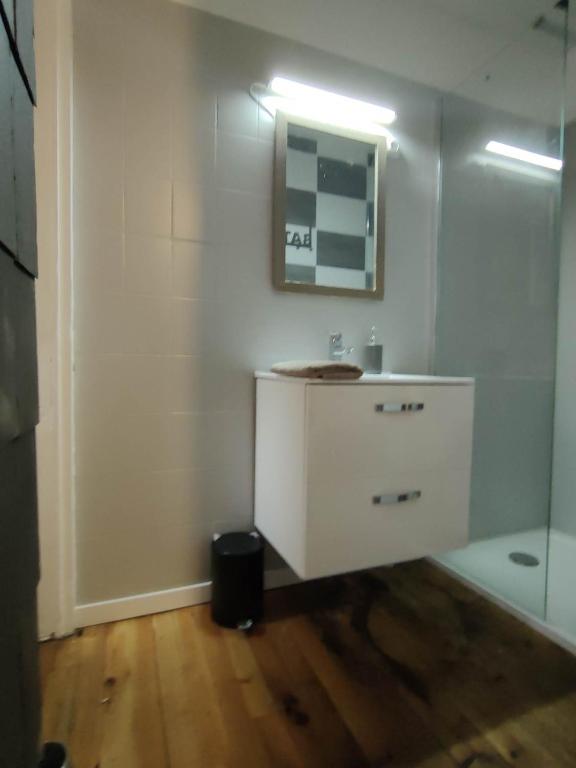 a white bathroom with a sink and a shower at Relais De La Tour in Callac