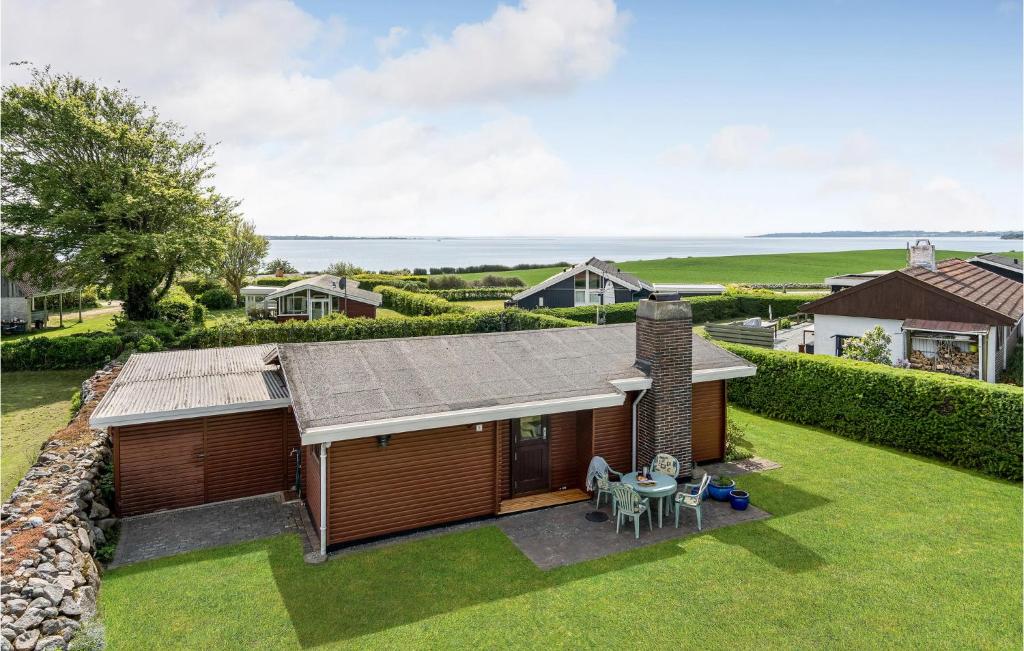 an overhead view of a house with a patio and a table at 2 Bedroom Awesome Home In Faaborg in Faaborg