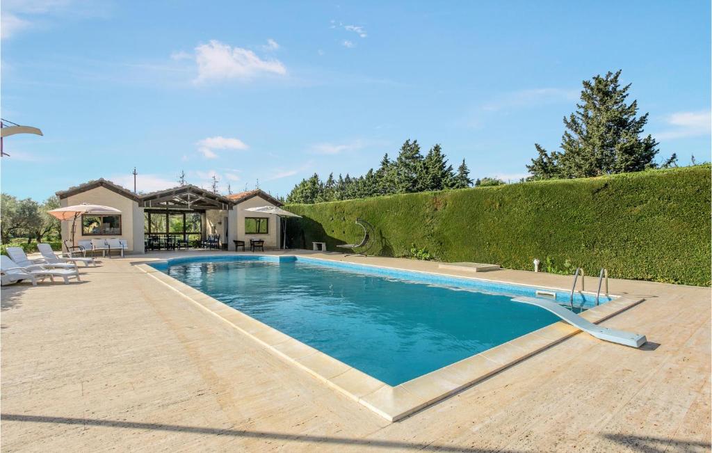 a swimming pool in the backyard of a house at Lovely Home In Comiso With House A Panoramic View in Comiso