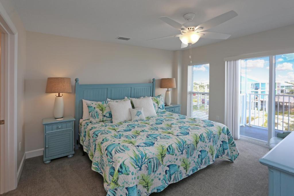 a bedroom with a bed with a blue bedspread at Surfside 16 by Pristine Properties Vacation Rentals in Mexico Beach