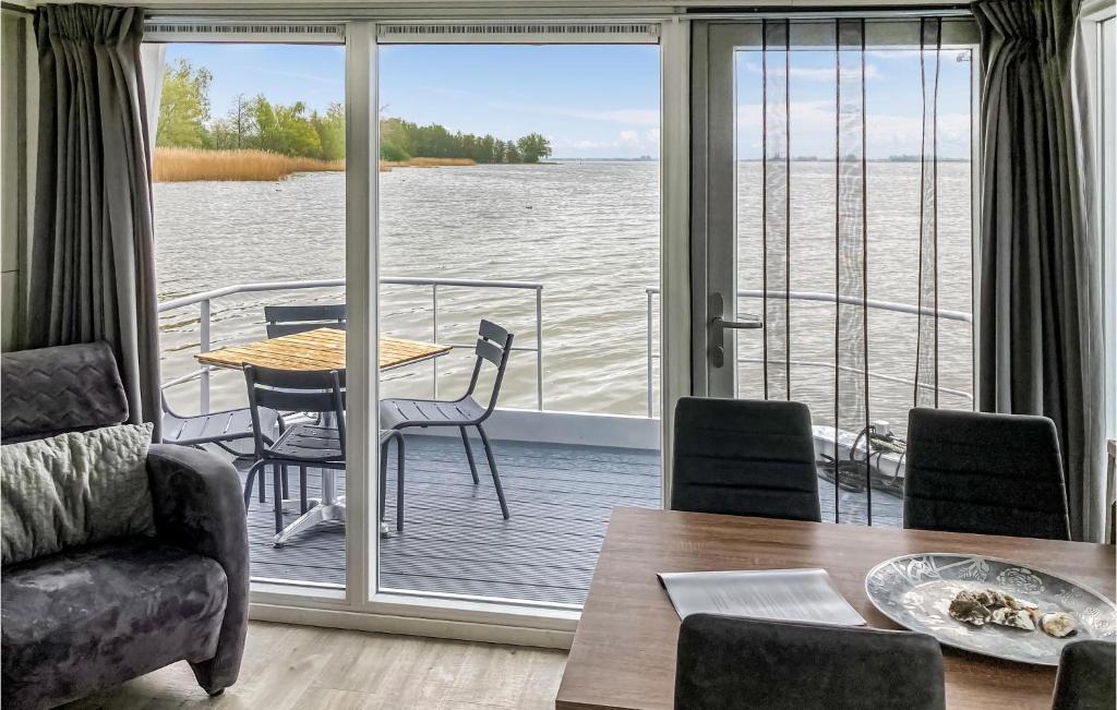 een woonkamer met uitzicht op het water bij Stunning Ship In Biddinghuizen With Lake View in Biddinghuizen