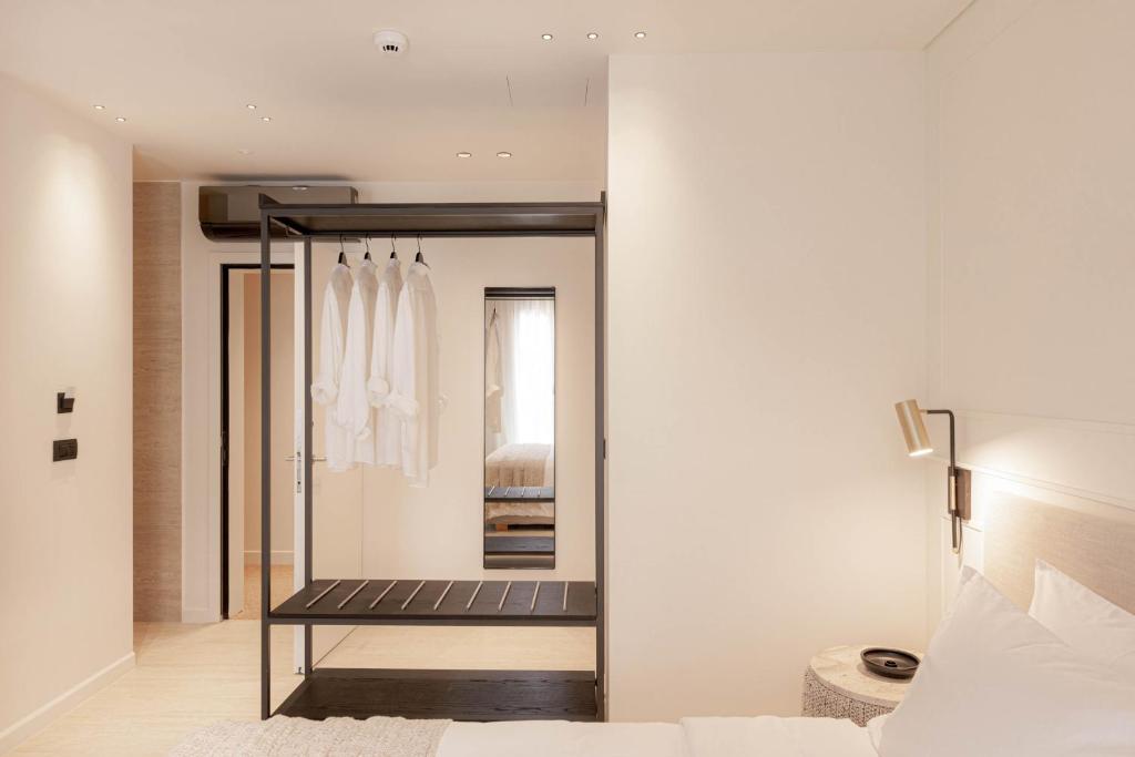 a dressing room with a mirror and a bed at Doryssa Theorem Hotel in Pythagoreio